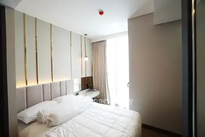 Luxurious bedroom with modern decor and ample natural light