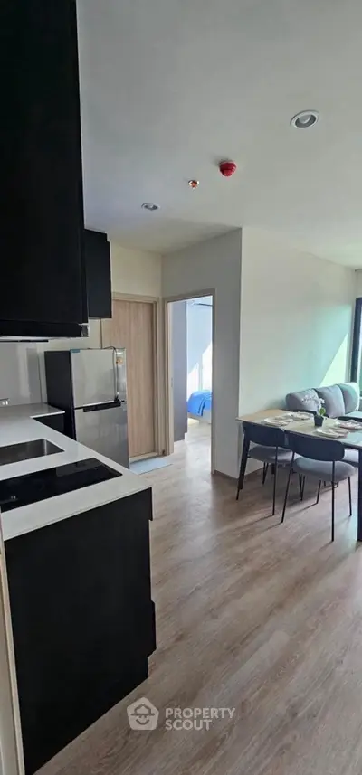Modern open-layout kitchen and dining area with sleek design and natural light.