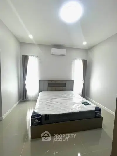 Spacious bedroom with modern minimalist design and natural light