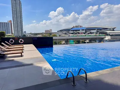 Luxurious rooftop infinity pool with stunning cityscape views and modern lounge chairs.
