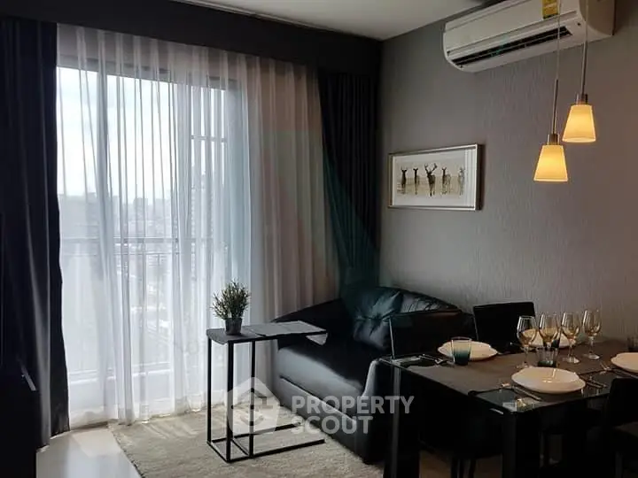 Modern living room with dining area and large window in stylish apartment