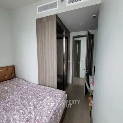 Cozy bedroom with modern wardrobe and stylish decor in a contemporary apartment.