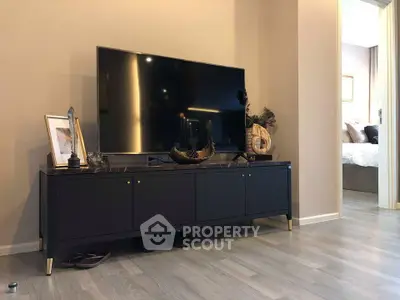 Modern living room with sleek TV stand and stylish decor in a contemporary apartment.