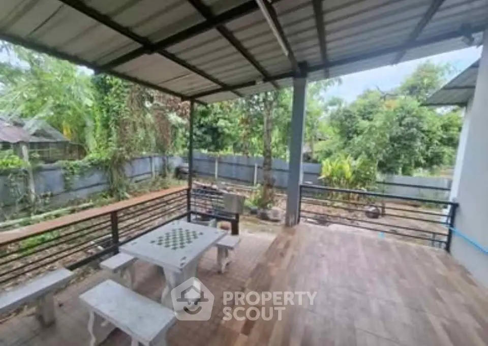 Spacious outdoor patio with seating and lush garden view, perfect for relaxation and entertaining.
