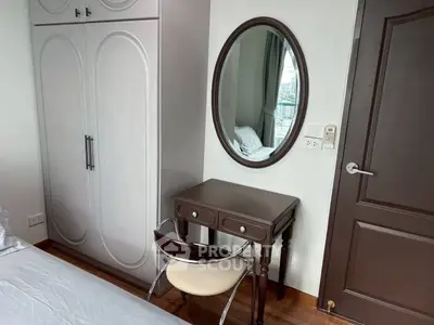 Cozy bedroom with elegant wardrobe and stylish vanity mirror