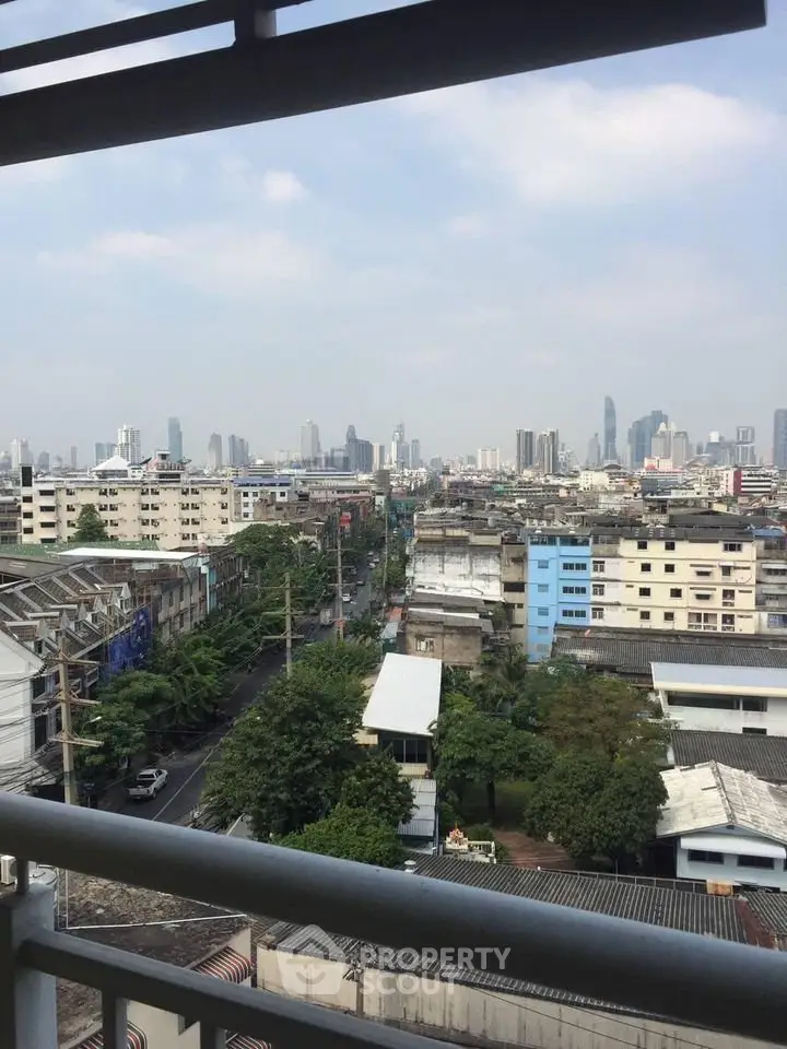 Stunning cityscape view from a high-rise balcony showcasing urban skyline and vibrant city life.