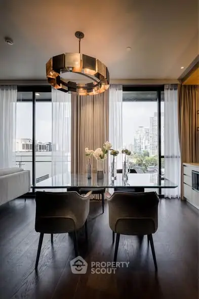 Luxurious dining area with modern chandelier and city view, perfect for elegant entertaining.
