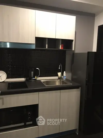 Modern kitchen with sleek black appliances and stylish cabinetry