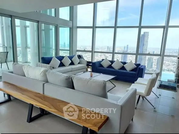 Luxurious high-rise living room with panoramic city views and modern furnishings.