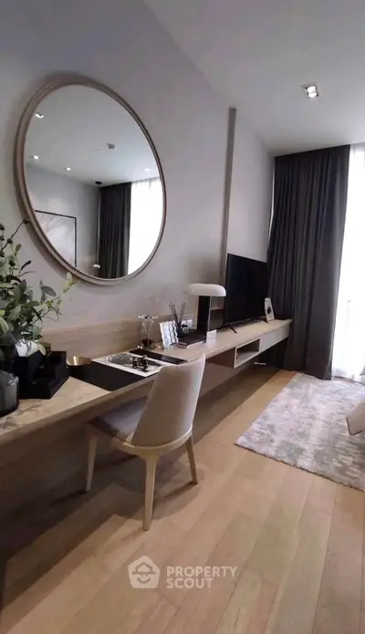 Modern living room with stylish decor, large mirror, and sleek TV setup