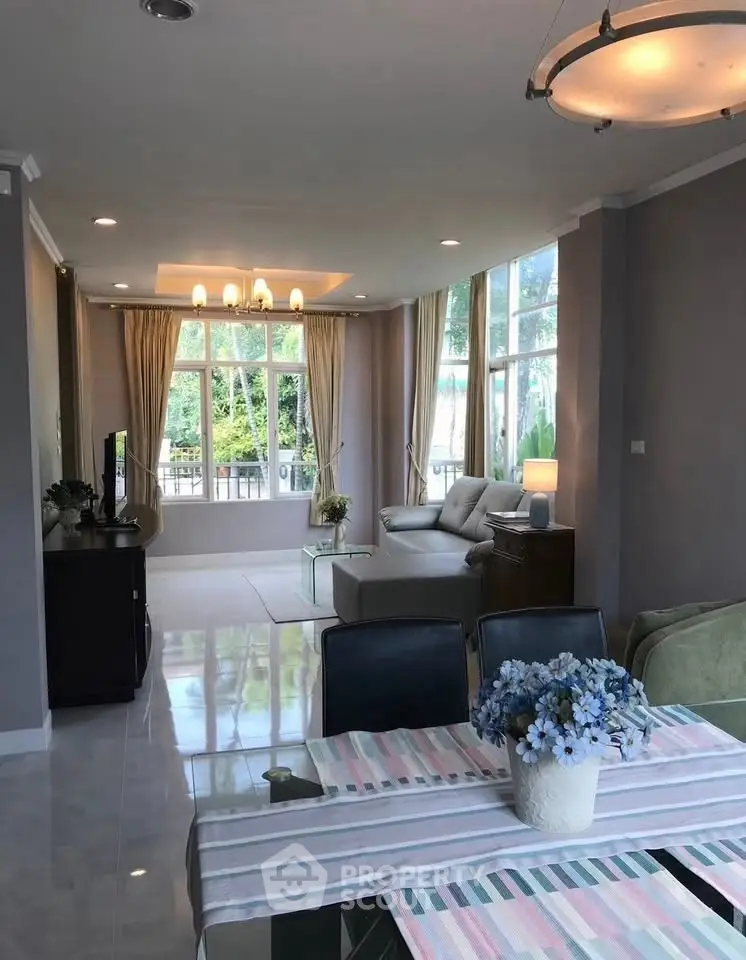 Spacious living room with large windows and elegant decor