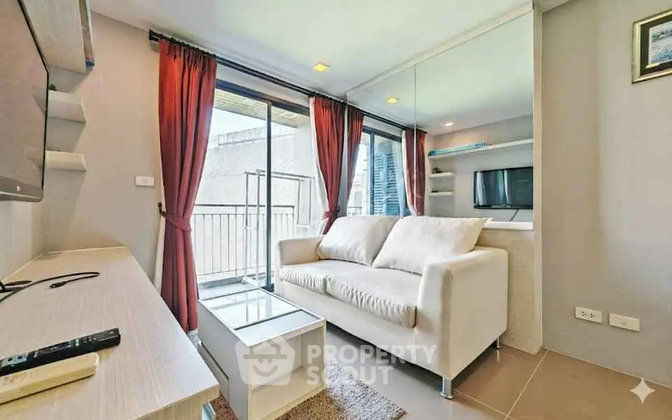 Modern living room with balcony access and stylish decor in urban apartment