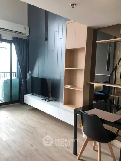 Modern living room with sleek design, featuring a TV, stylish shelving, and a balcony view.