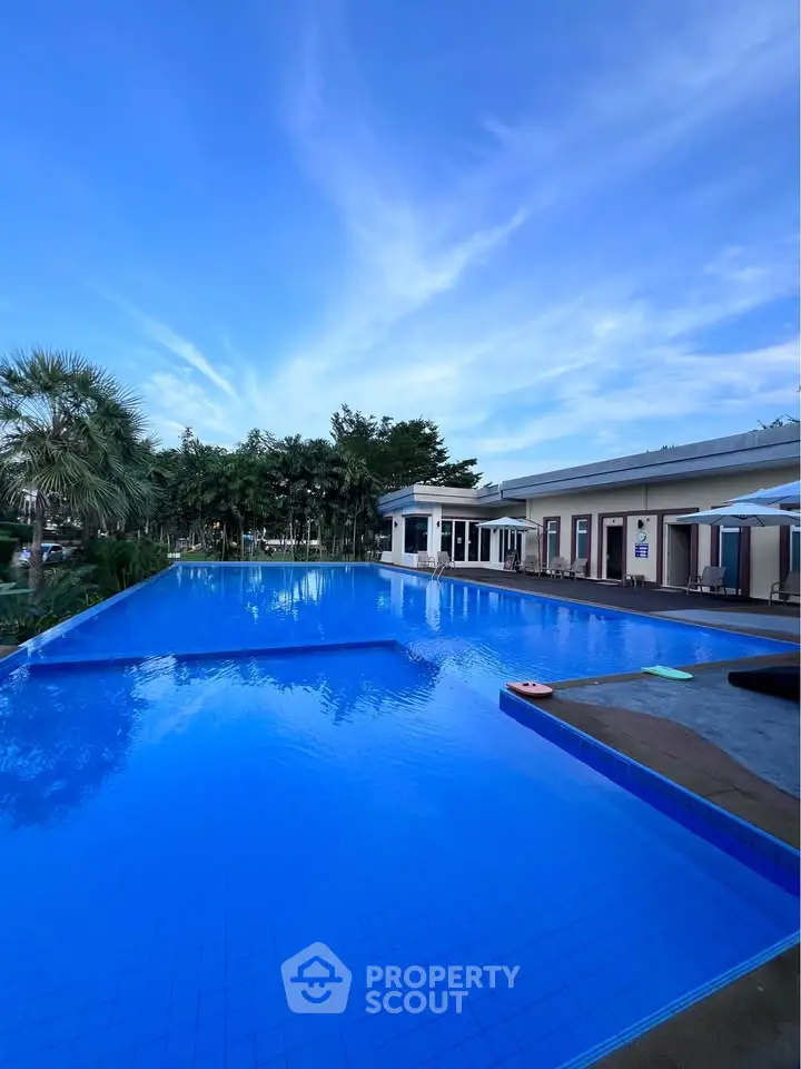 Luxurious outdoor pool area with clear blue water and modern amenities, perfect for relaxation and leisure.