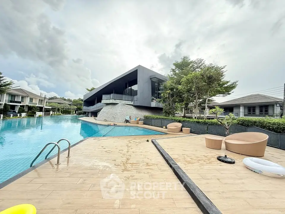 Luxurious modern poolside view with sleek architecture and serene surroundings.