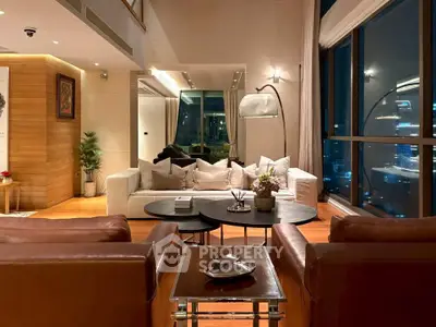 Luxurious living room with stunning city view, elegant decor, and cozy seating area in a high-rise apartment.