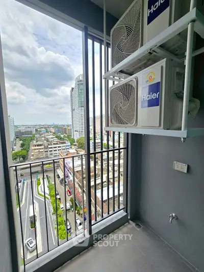 Modern balcony with city view and air conditioning units in a high-rise building.