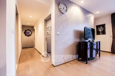 Modern living room with sleek wooden flooring and stylish decor
