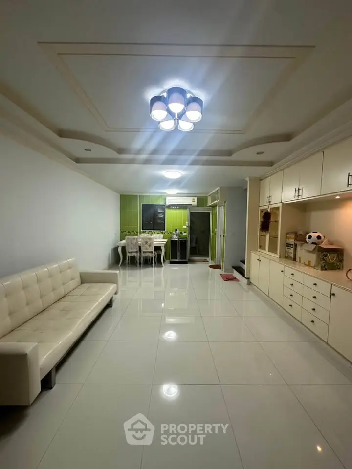 Spacious modern living room with elegant lighting and sleek furniture