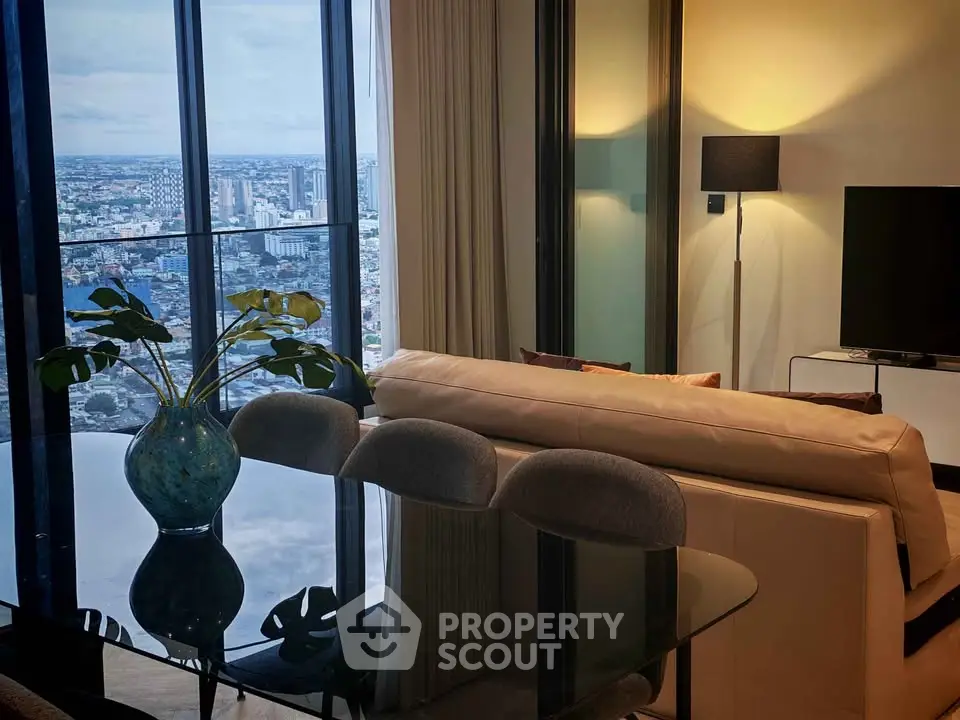 Luxurious living room with stunning city view, modern furniture, and elegant decor in high-rise apartment.