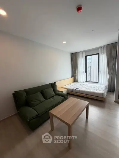 Modern studio apartment with cozy living area and natural light