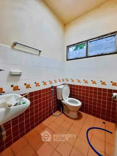 Cozy bathroom with tiled walls and modern fixtures in a real estate property.