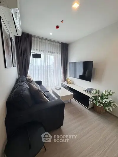 Modern living room with sleek decor and large window view