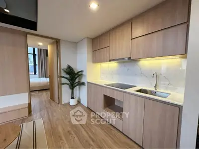 Modern open kitchen with sleek wooden cabinetry and marble backsplash