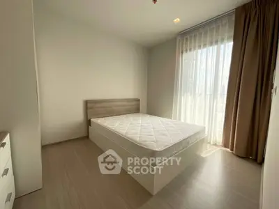 Bright minimalist bedroom with large window and modern furnishings
