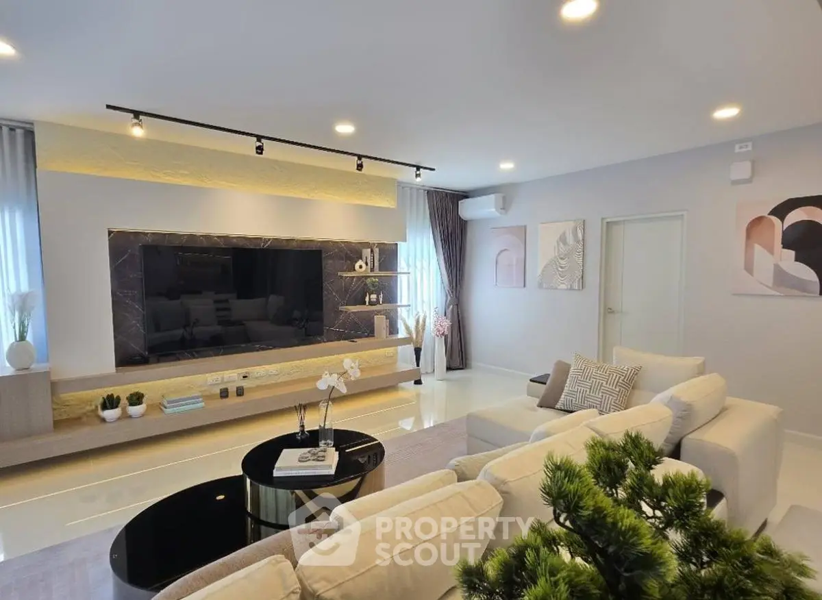 Luxurious modern living room with sleek design and large TV setup