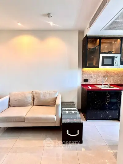 Modern living room with sleek kitchenette and cozy sofa in stylish apartment