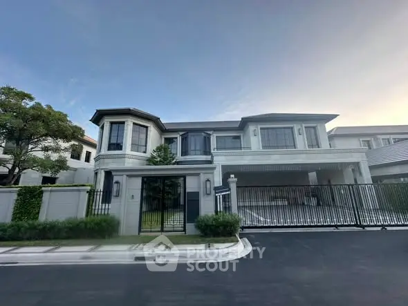 Luxurious modern mansion with gated entrance and elegant architecture