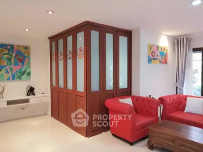 Stylish living room with vibrant red sofas and modern art decor