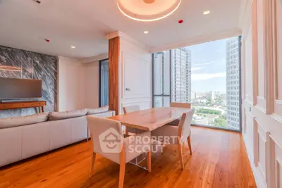 Spacious modern living room with wooden flooring and city view, featuring elegant dining area and cozy seating.