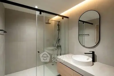 Modern bathroom with glass shower and sleek vanity