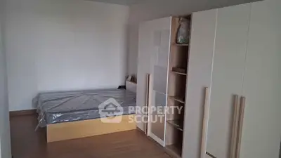 Minimalist bedroom with modern wardrobe and bed frame, perfect for cozy living.