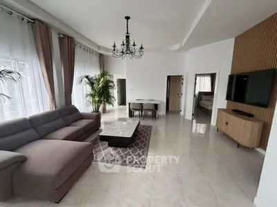 Spacious living room with elegant chandelier and modern furniture