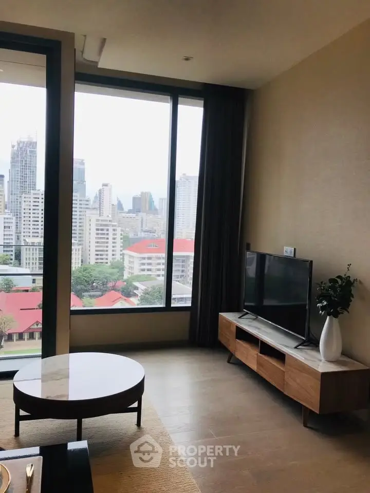 Modern living room with large window offering stunning city view, stylish furniture, and elegant decor.