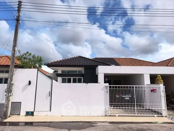 Charming suburban house with modern design and gated entrance, perfect for family living.