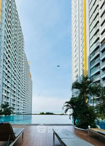 Luxurious high-rise apartment with stunning poolside view and modern amenities.