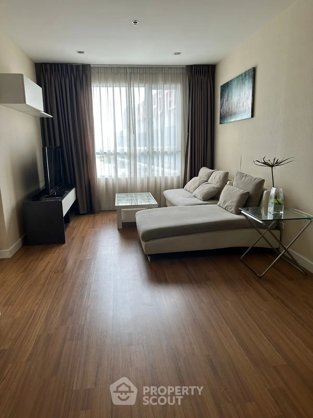 Modern living room with sleek furniture and large window for natural light