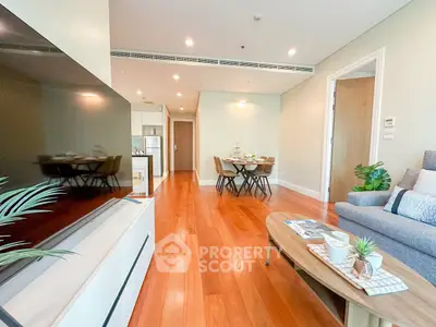 Spacious living room with modern decor and wooden flooring