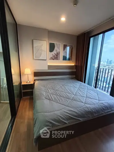 Modern bedroom with city view and stylish decor in high-rise apartment.
