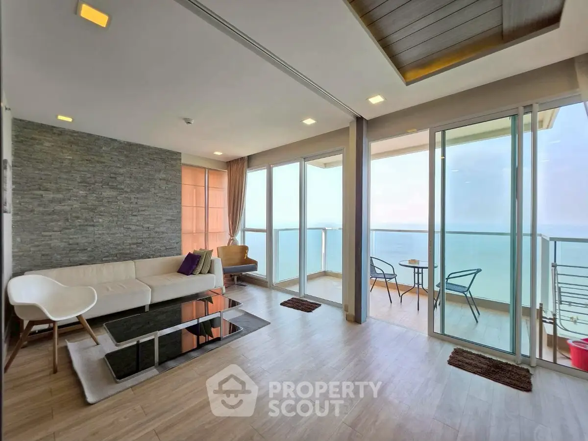 Stunning living room with ocean view and spacious balcony in modern apartment