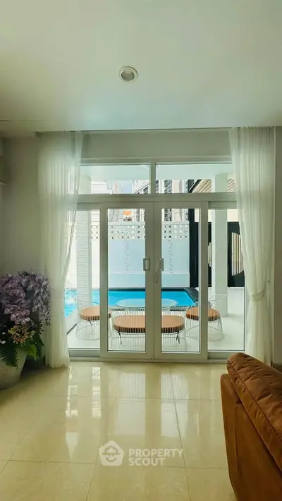 Luxurious living room with pool view and elegant decor