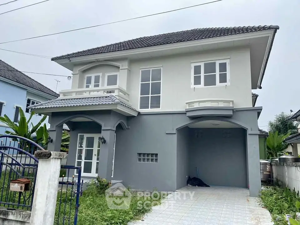 Charming two-story house with modern design and spacious driveway in a serene neighborhood.