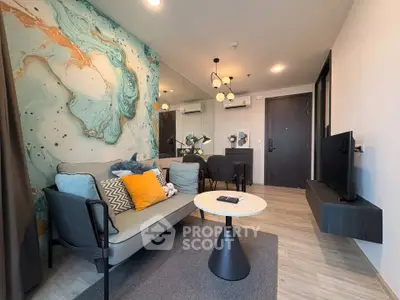 Stylish modern living room with artistic wall design and cozy seating area.