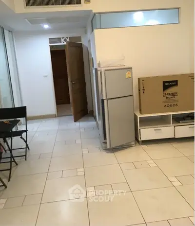 Spacious interior with tiled flooring and modern appliances, ideal for urban living.