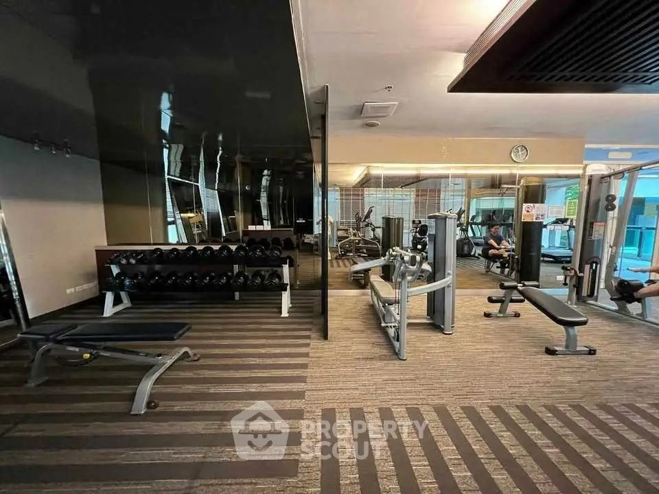 Modern gym with state-of-the-art fitness equipment and sleek design.