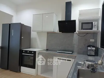 Modern kitchen with sleek appliances and stylish cabinetry, perfect for culinary enthusiasts.